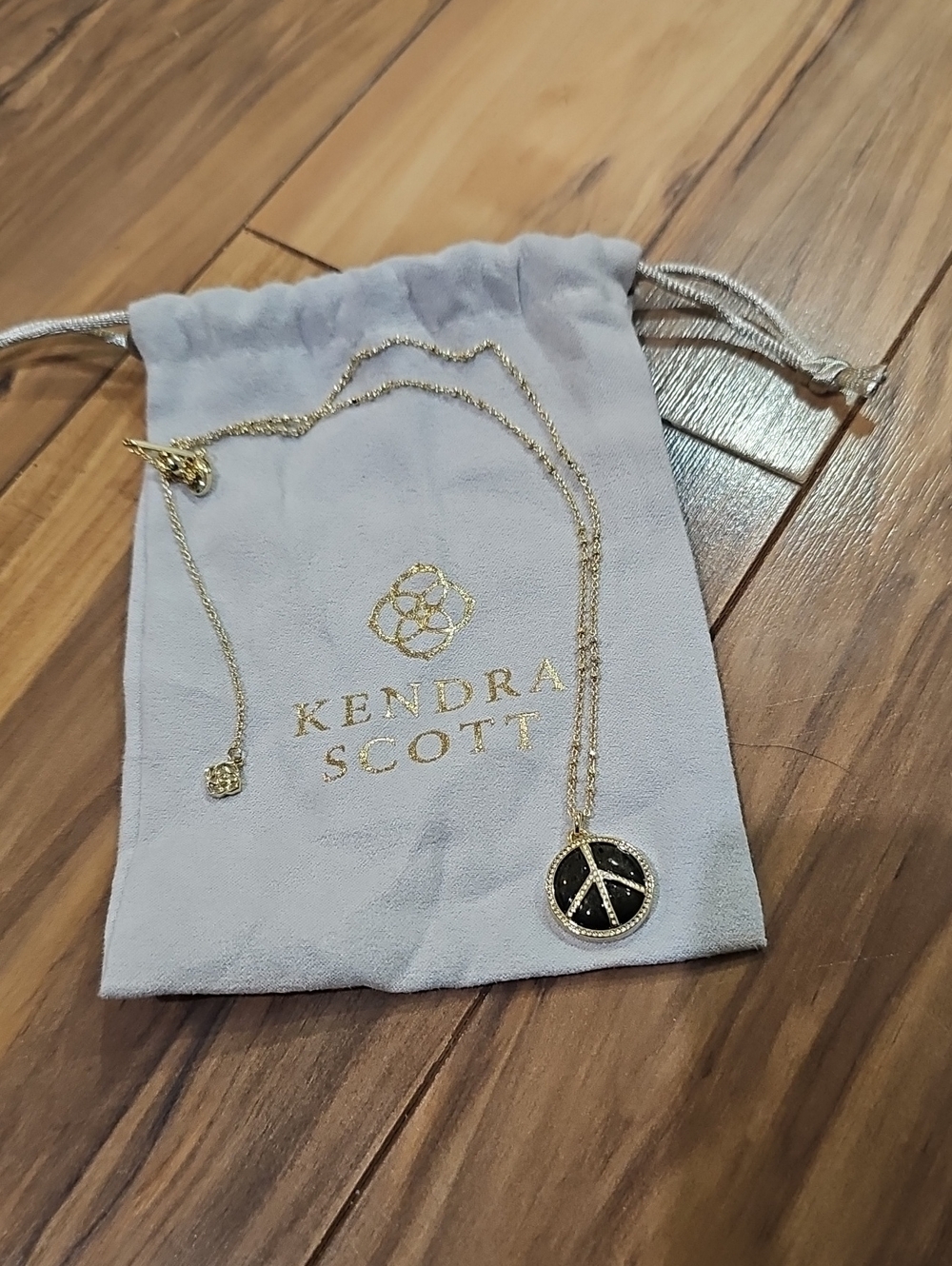 Kendra Scott Gold Necklace with Black Peace Pendant